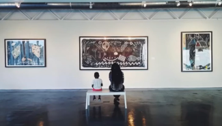photo of viewers of art at Houston Museum of African American Culture