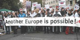 protest group advocating for de,ocracy in europe with banner - photo