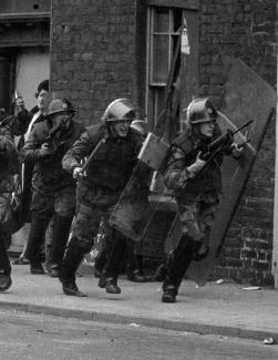 photo of men in military uniform with guns