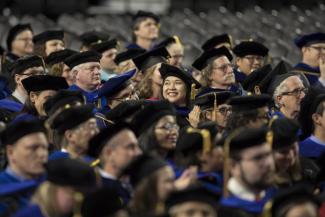 graduate commencement at uga - photo of crowd of gradaute students in graduation regalia