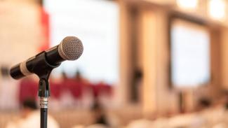 Photo of a microphone in a lecture hall