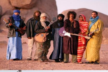 photo of musical band in desert and photo of armed militants in desert