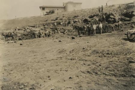 Building Sanford Stadium, historic photo of men digging a dirt field