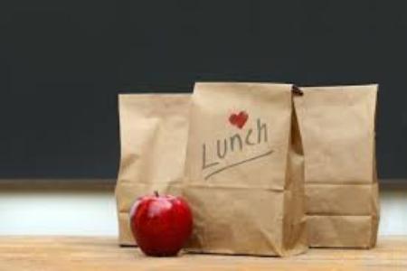 brown lunch bags and one apple
