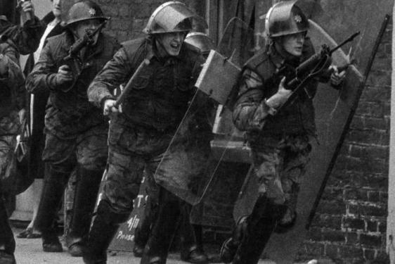 photo of men in military uniform with guns