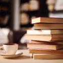 image of a stack of untitled books and a tea cup
